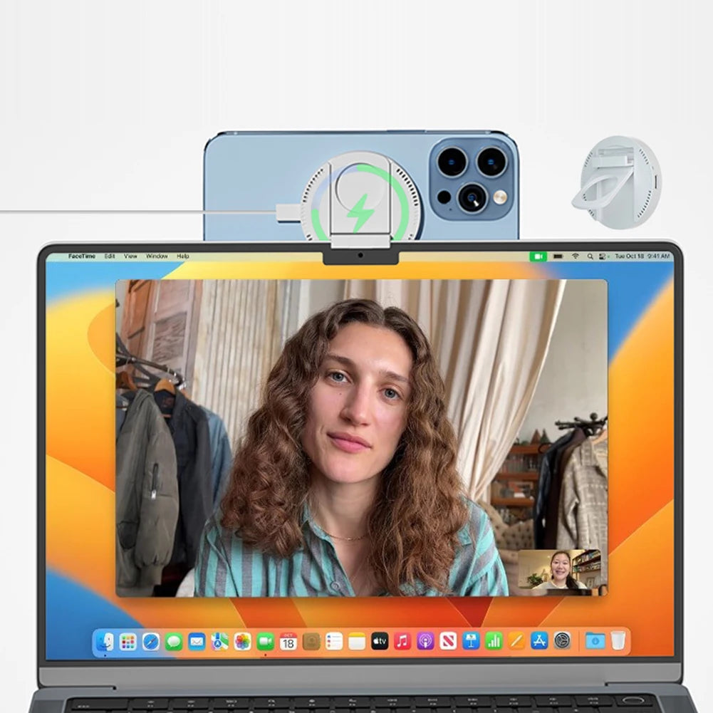 MagSafe charger stand mounted on a laptop screen, powering a FaceTime video call via Continuity Camera